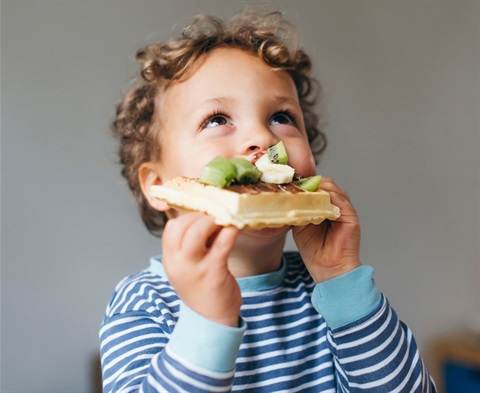 Child eating waffle with fruit.jpg