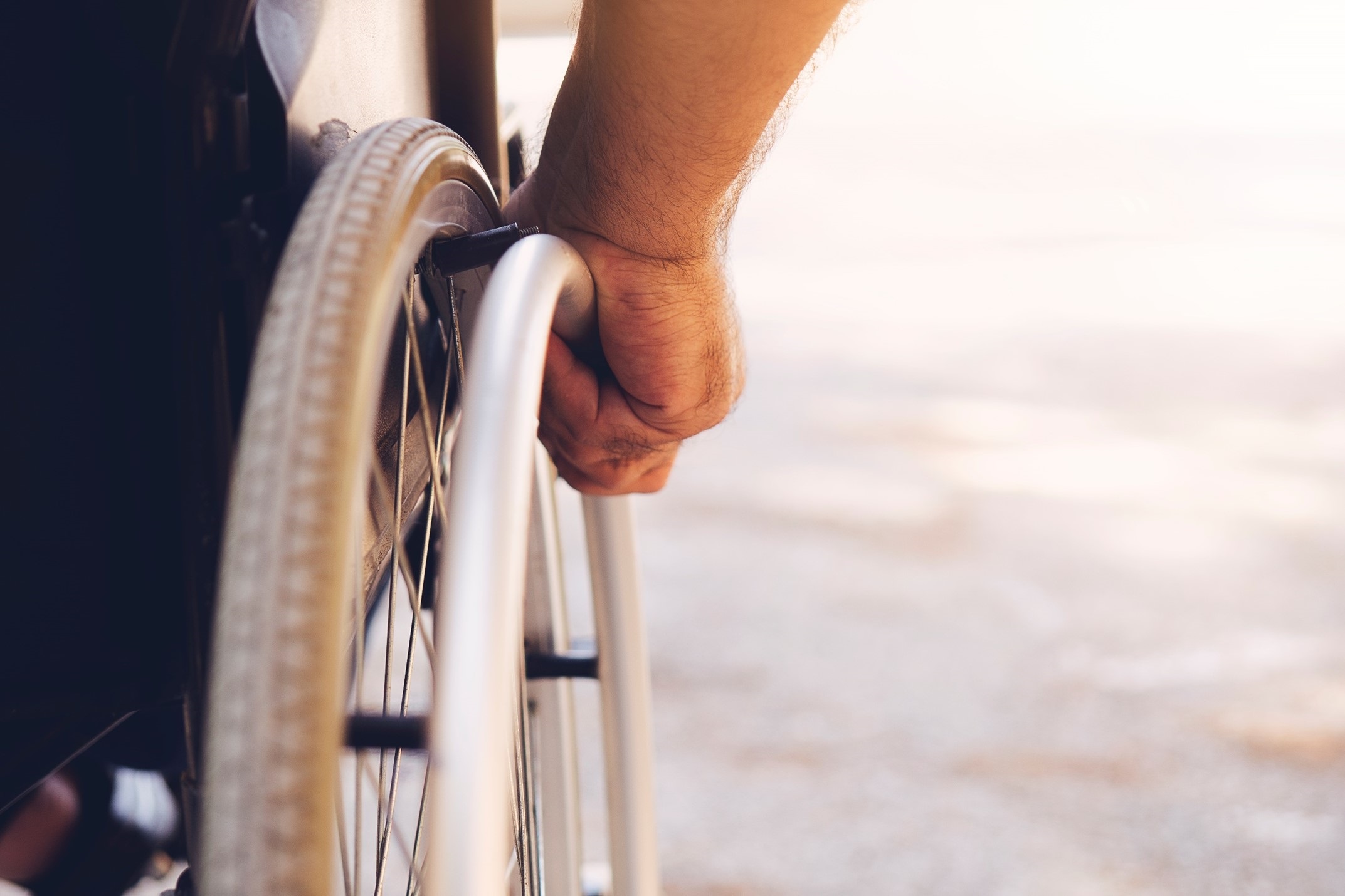 hand on hand rim of wheelchair 