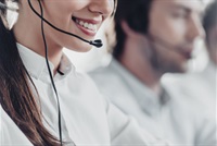 smiling female call operator wearing a headset