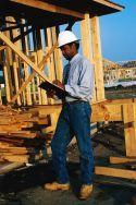inspector at construction site holding clipboard