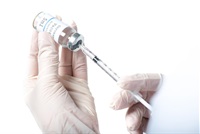 hands with white gloves holding a syringe and a vaccination